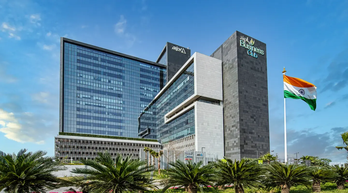 AIPL Business Club office blocks on Golf Course Extension Road with the Indian flag at the entrance