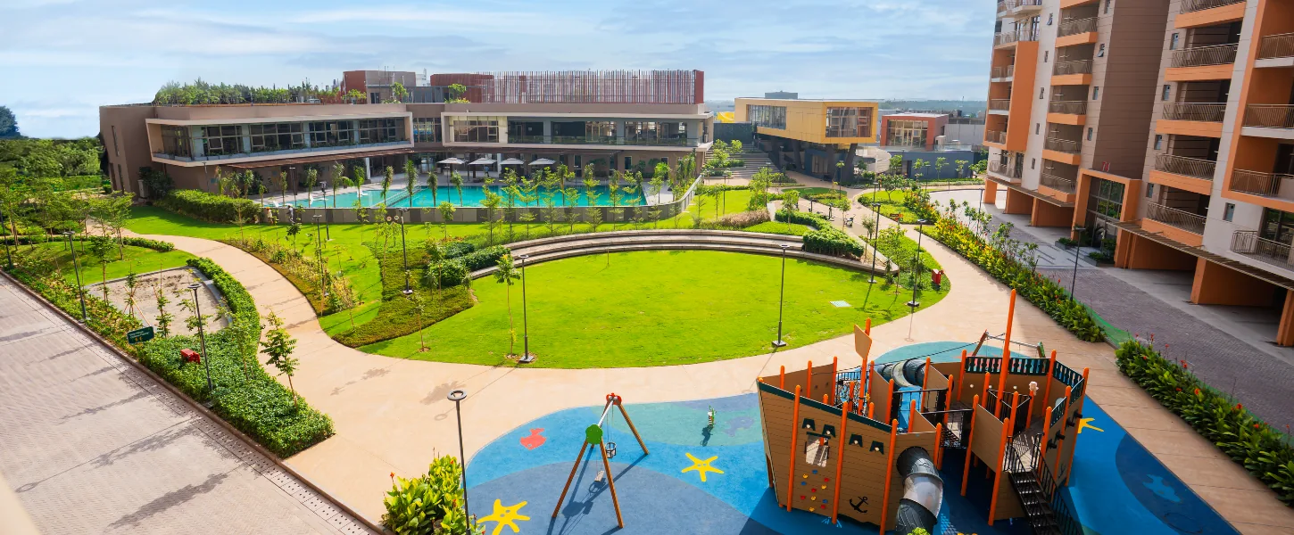 Ashiana Amarah ship-shaped kids' play area beside the oval lawn, developer photo