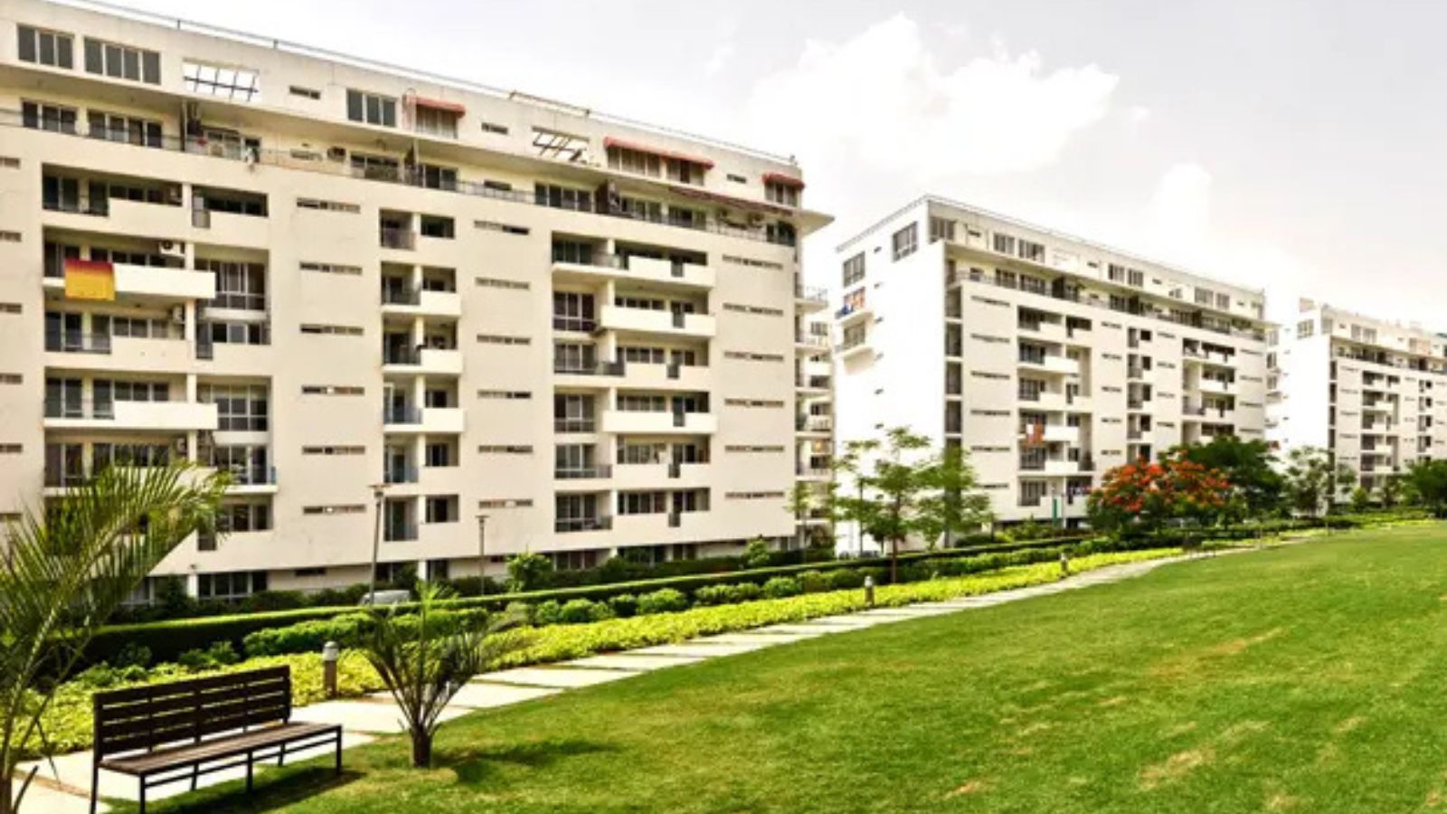 Vatika City mid-rise apartment blocks and landscaped lawn with benches
