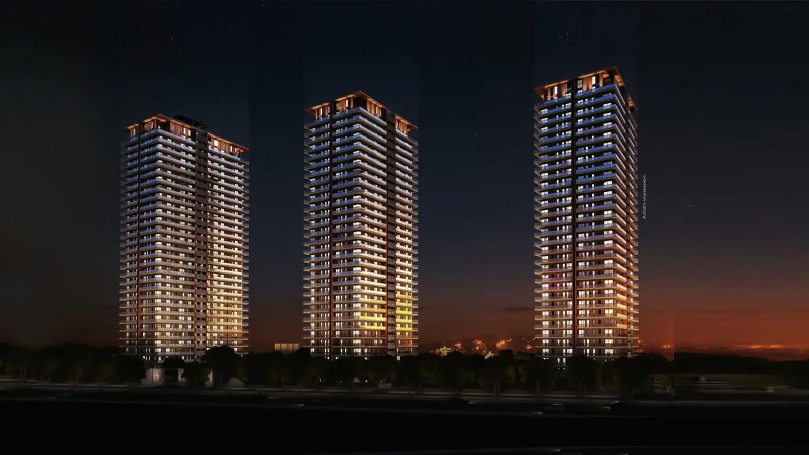 Mahindra Luminare three towers lit at dusk