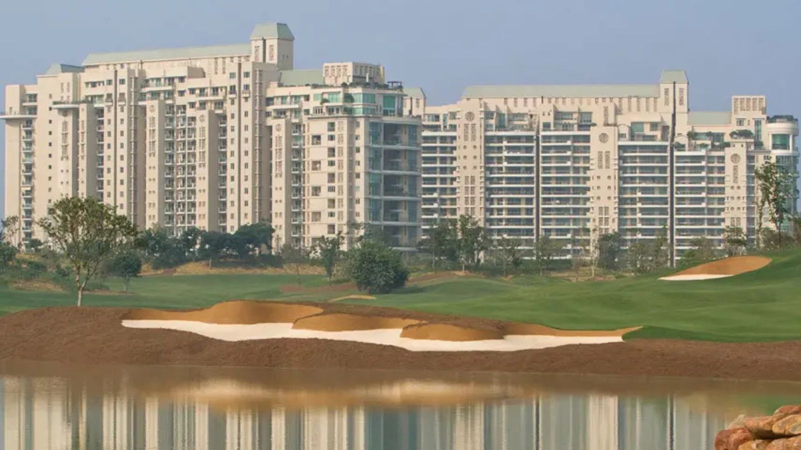 DLF The Magnolias towers across the golf course bunker and lake