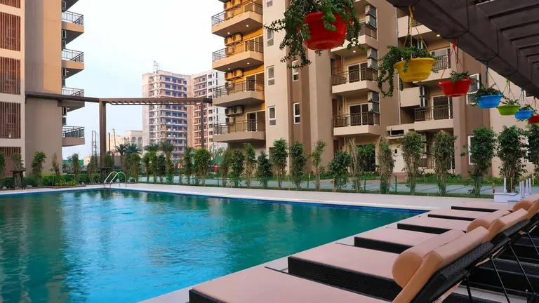 Adani M2K Oyster Grande swimming pool with sun deck and tower balconies, photo
