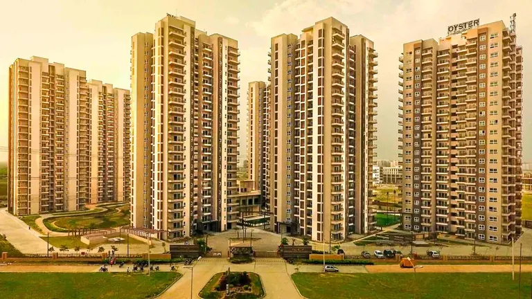 Adani M2K Oyster Grande residential towers around the landscaped central green, photo