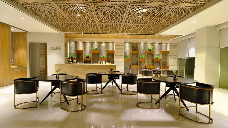Adani M2K Oyster Grande clubhouse cafe and lounge seating, photo