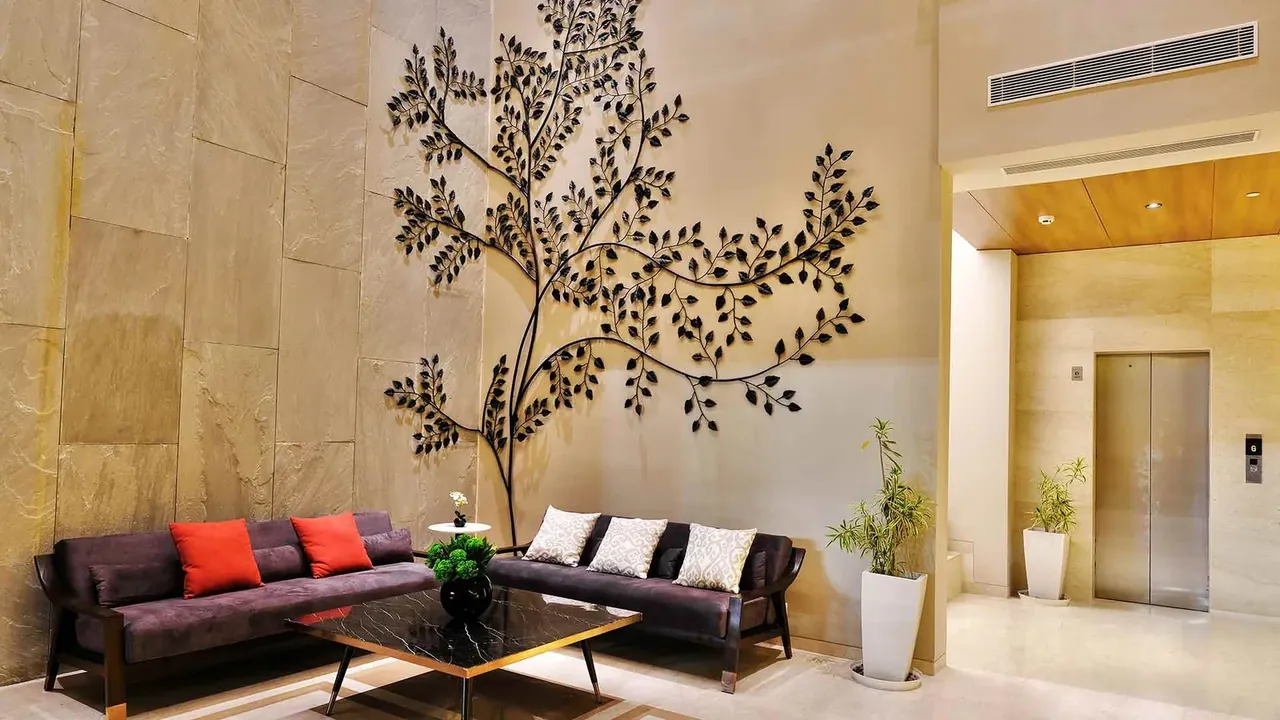 Adani M2K Oyster Grande tower entrance lobby with lift and seating, photo