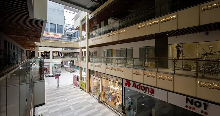 AIPL Joy Central upper retail corridor with the glass balustrades
