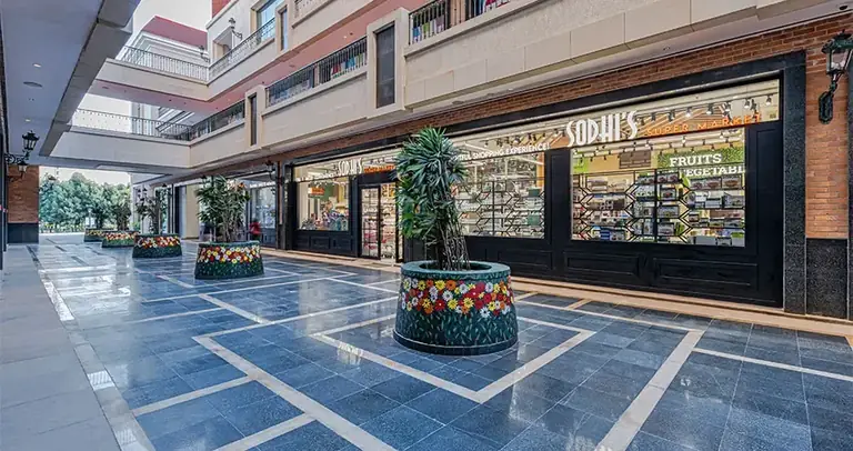 AIPL Joy Street high-street shopping corridor with marble flooring and storefronts