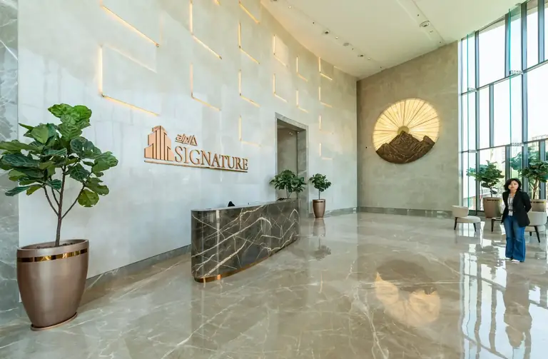 AIPL Signature lobby with the reception desk and glass wall