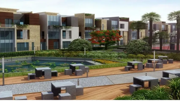 Ansal API Esencia low-rise floors behind a landscaped sit-out with pool and seating, artist's impression