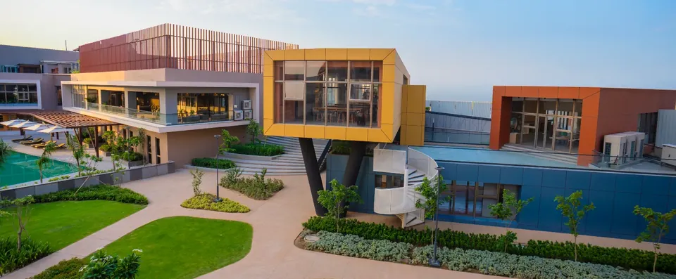 Ashiana Amarah clubhouse with its yellow upper room above the pool deck, developer photo