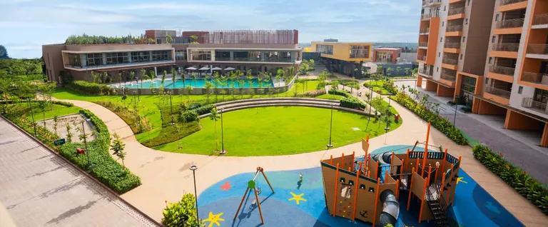 Ashiana Amarah ship-shaped kids' play area beside the oval lawn, developer photo