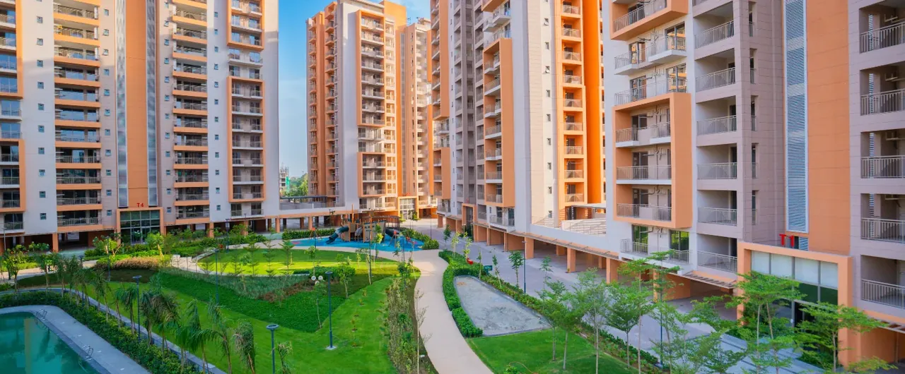 Ashiana Amarah towers framing the inner garden and pool, developer photo