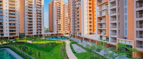 Ashiana Amarah towers framing the inner garden and pool, developer photo