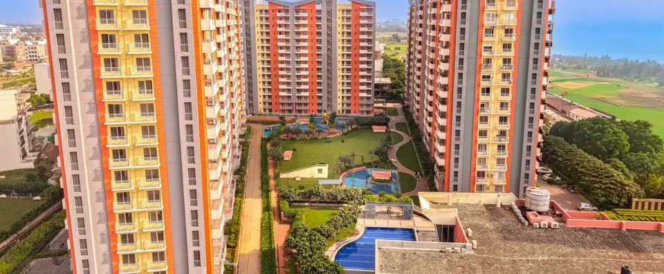 Ashiana Anmol central garden and pool between the towers