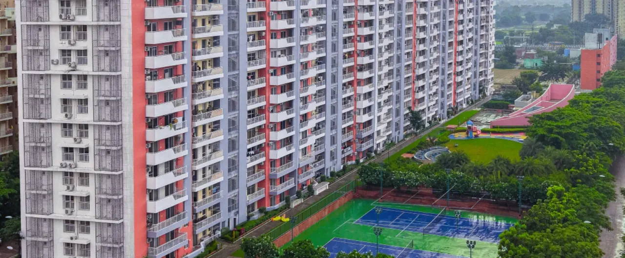 Ashiana Anmol towers above the tennis courts and gardens