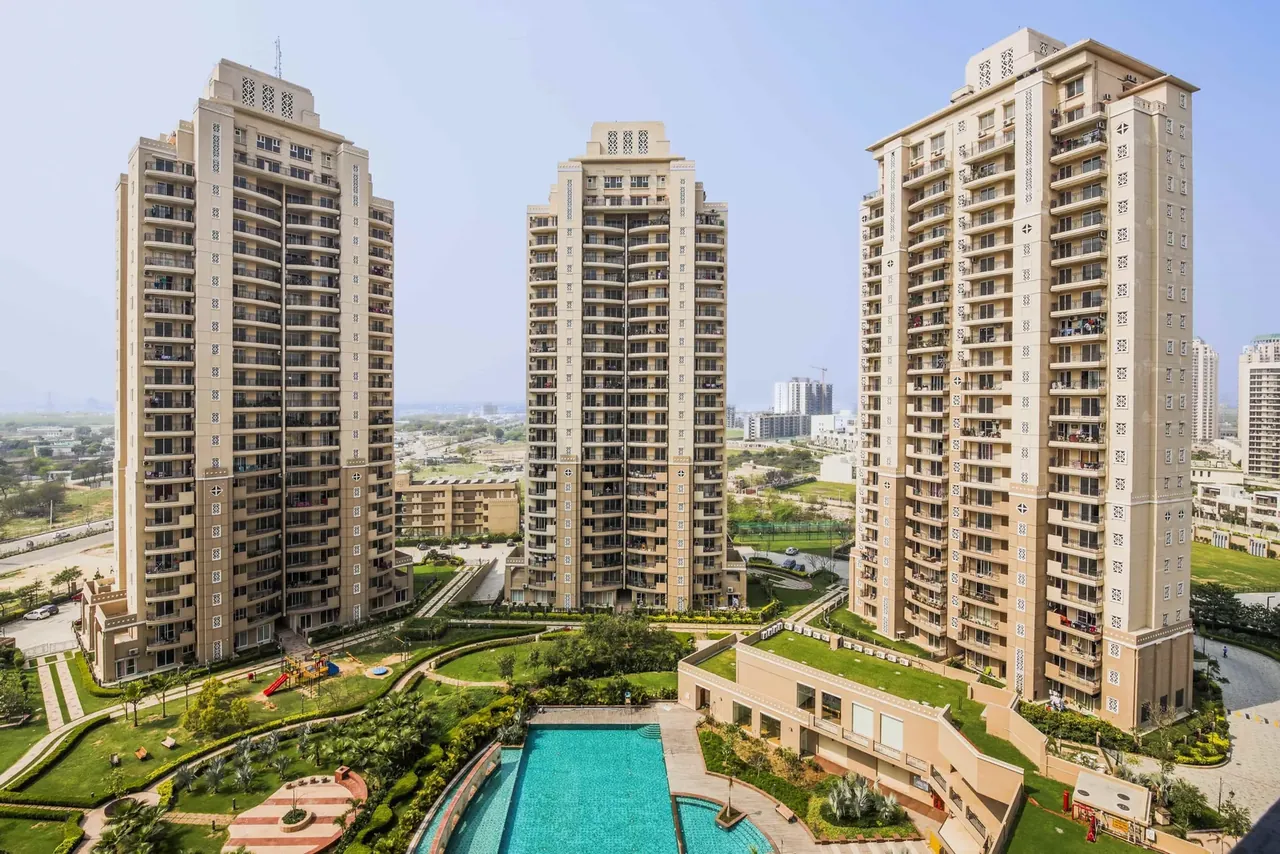 ATS Kocoon completed towers, clubhouse pool and landscaped courtyard from above, photo