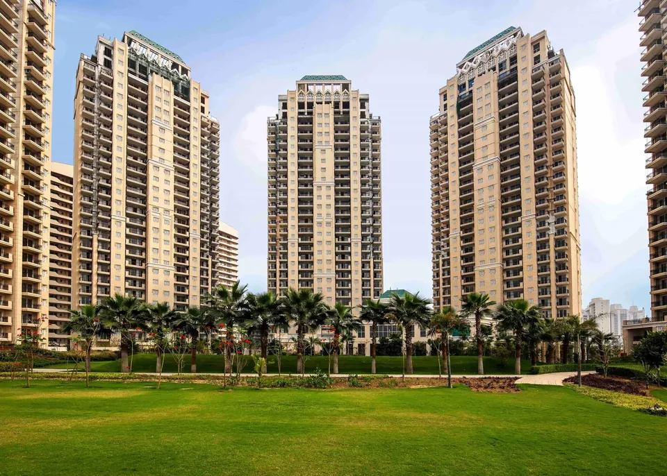 ATS Tourmaline three towers behind the open lawn and palm line, photo
