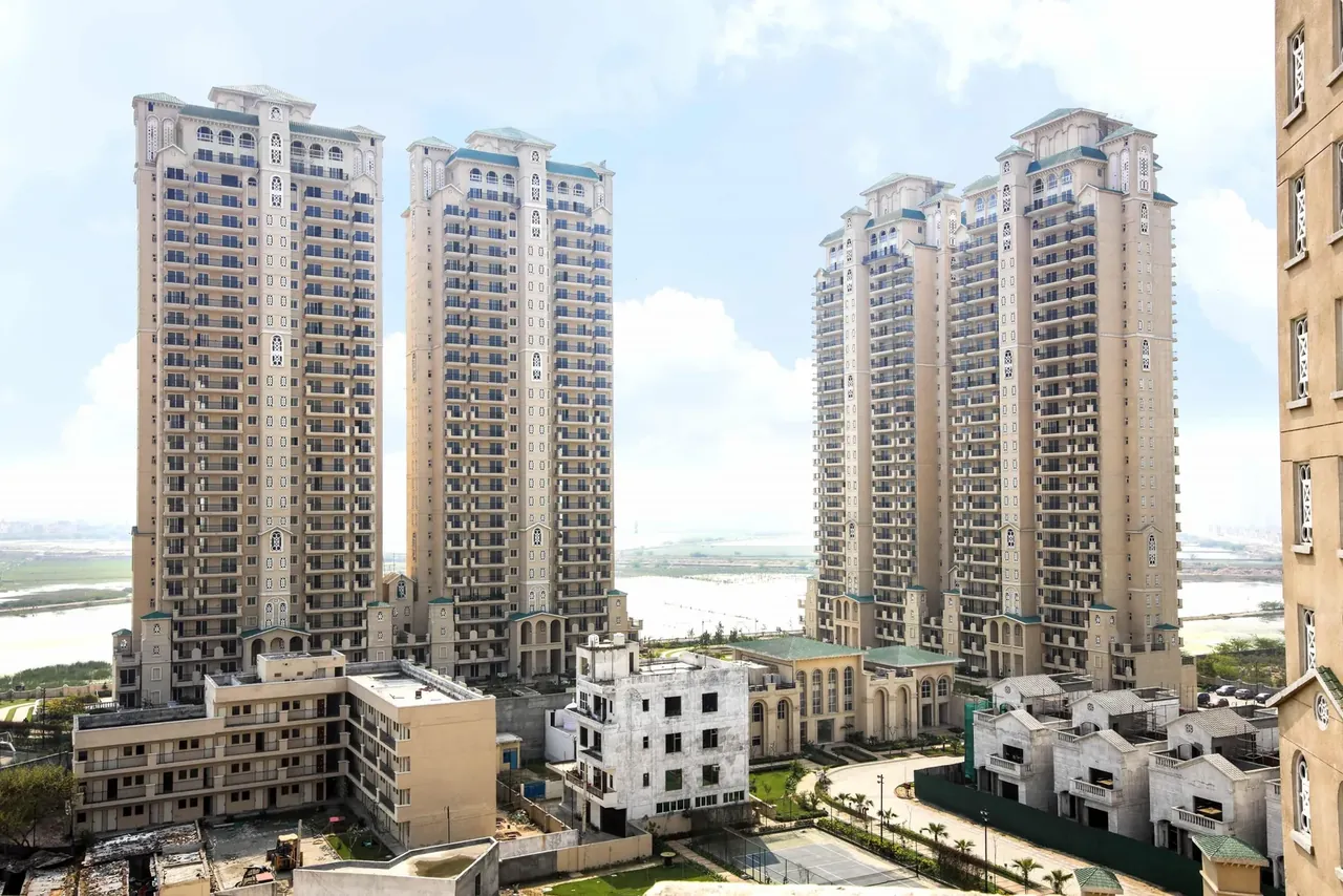 ATS Triumph apartment towers with the low-rise villas in front, photo