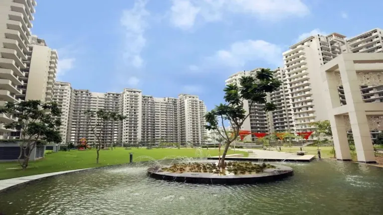 Bestech Park View Spa Next towers around a landscaped pond with a planted island