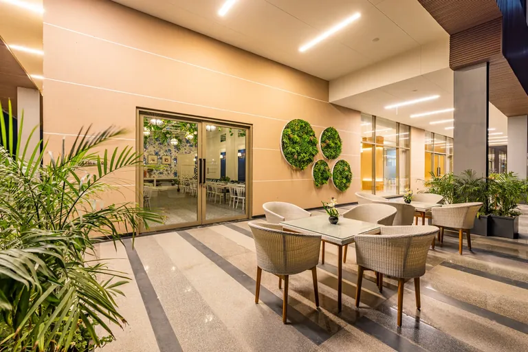 BPTP Amstoria clubhouse cafe seating by the glass doors, photo
