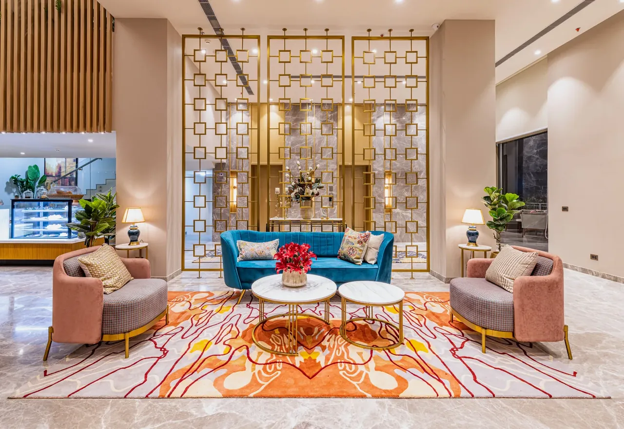BPTP Amstoria clubhouse lounge with screen partitions and sofas, photo