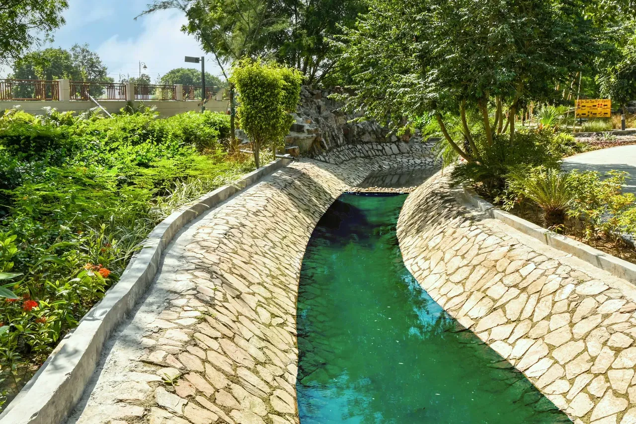 BPTP Astaire Gardens stone-lined water channel running through the landscaped greens