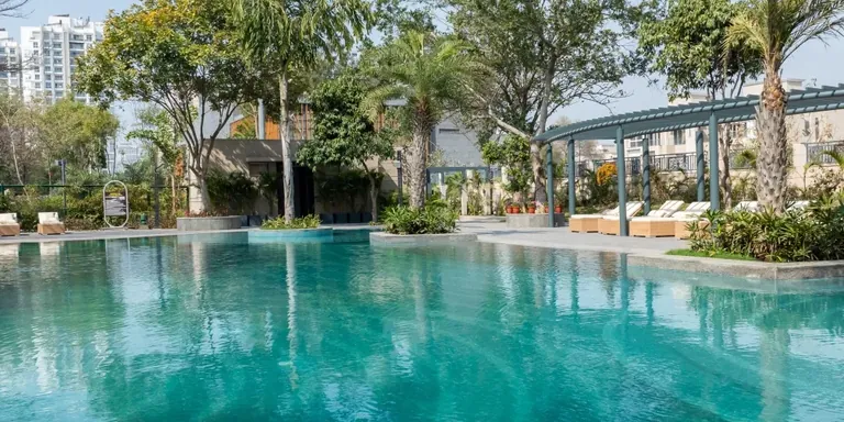 BPTP Astaire Gardens swimming pool with sun loungers and pergola deck