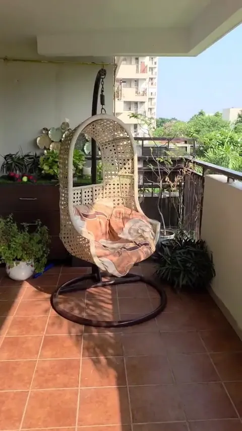 Brisk Lumbini Terrace Homes balcony with a swing chair and the neighbouring towers, actual photograph