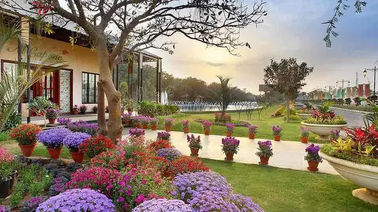 Central Park Cerise Floors flower garden in front of the homes
