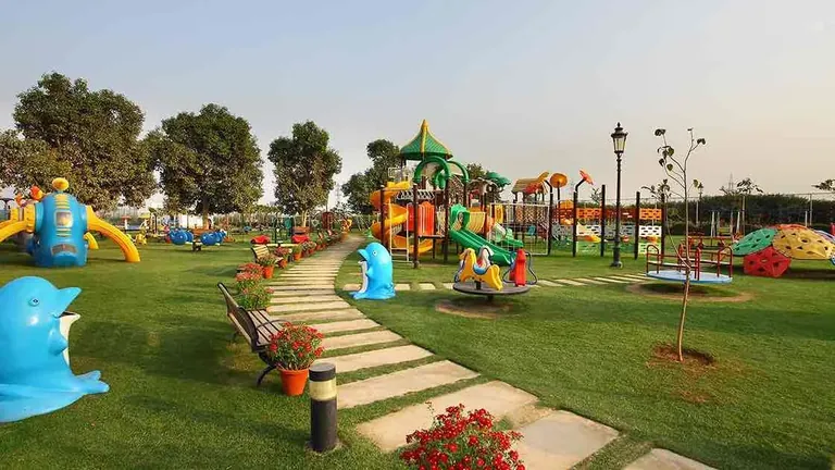 Central Park Cerise Floors kids play area with slides on the lawn