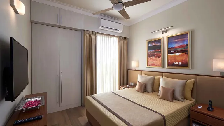 Central Park Flamingo Floors master bedroom with a split AC and wardrobe