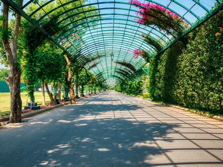 Central Park Fleur Villas flower-covered pergola walkway on a township road