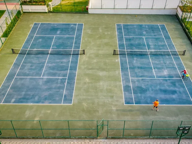 Central Park Mikasa Plots two tennis courts inside the township