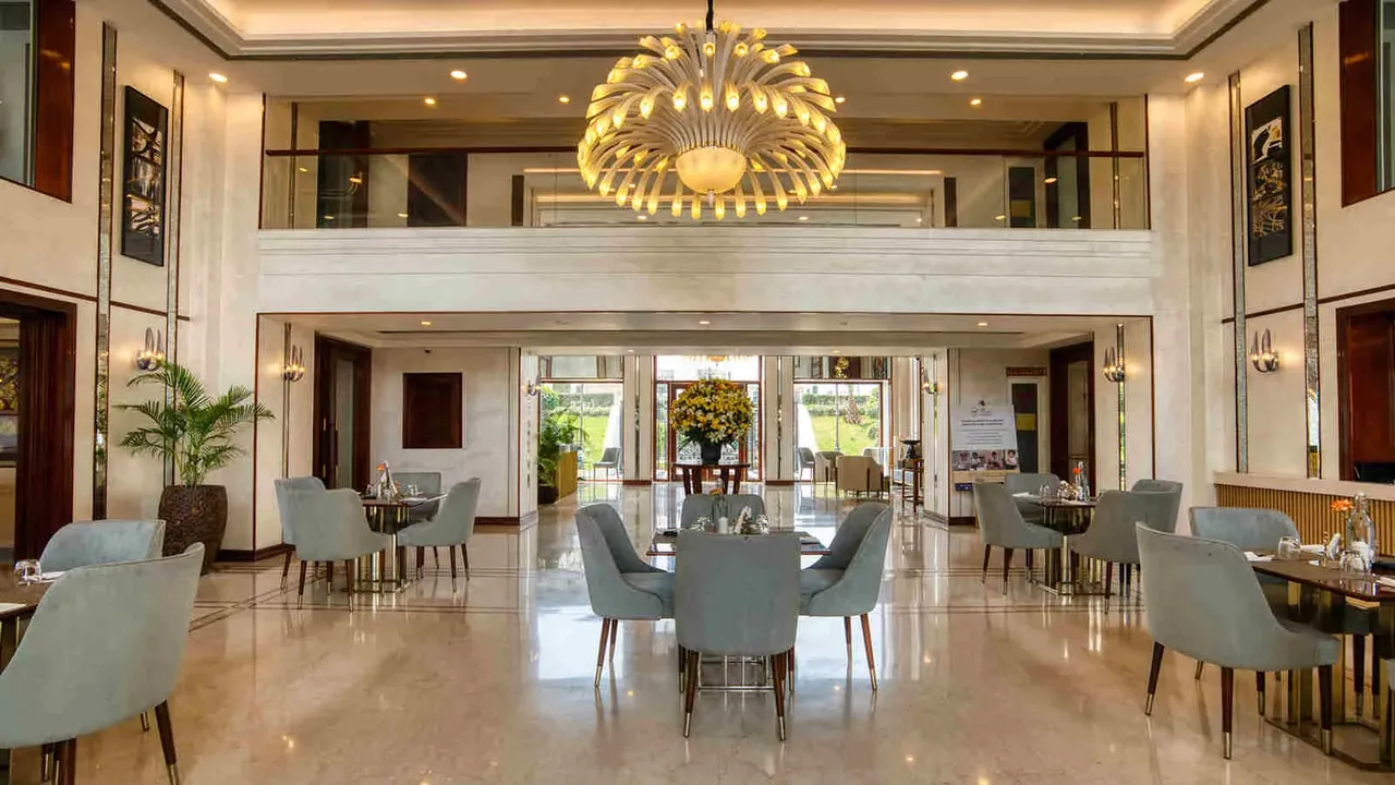 Central Park The Room double-height lobby lounge with a chandelier
