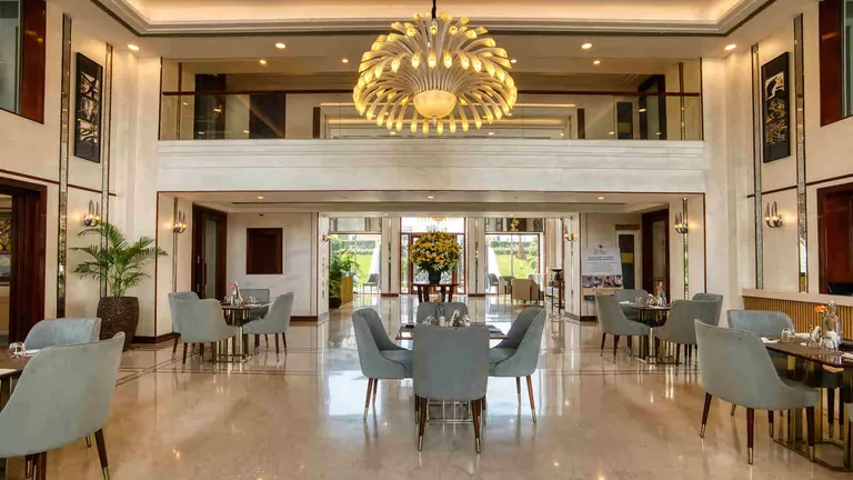 Central Park The Room double-height lobby lounge with a chandelier