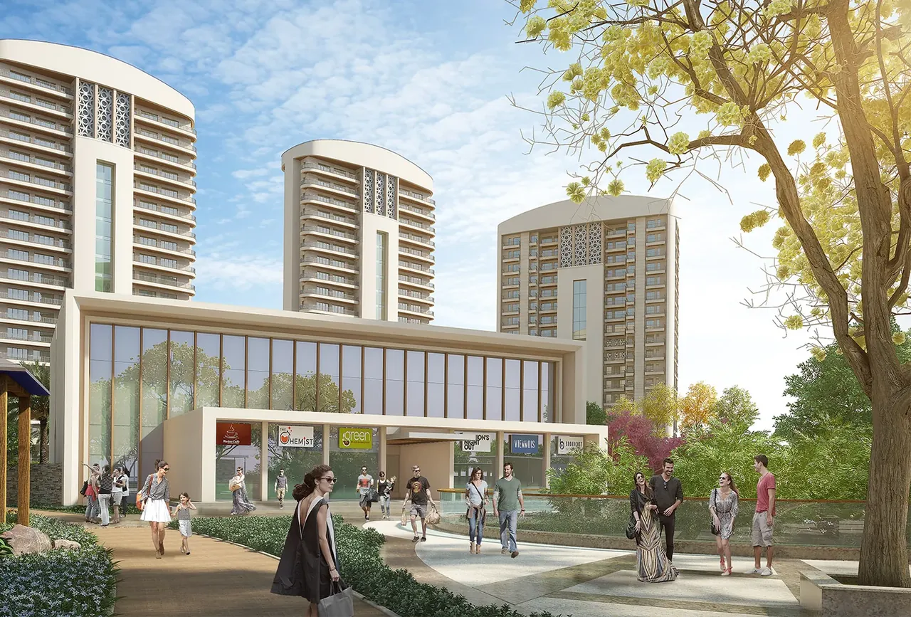 Chintels Serenity club plaza with glass-fronted clubhouse and towers behind, artist's impression