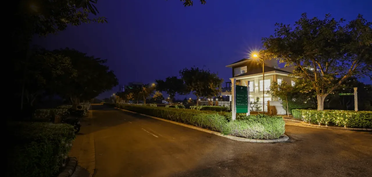 DLF Alameda residential street at dusk with street lights and greens, actual photo