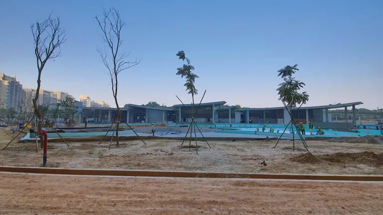 DLF The Camellias club pavilion by the water at dusk