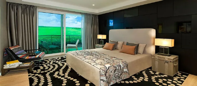 DLF The Crest sample apartment bedroom with a golf course view