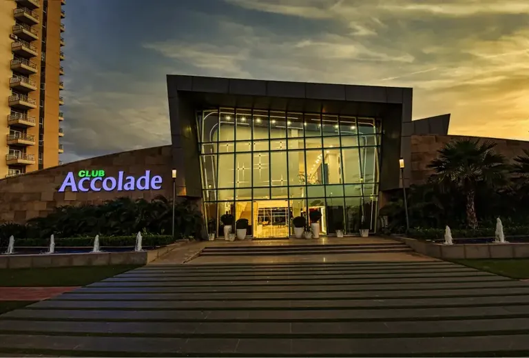 Eldeco Accolade Club Accolade entrance lit up at dusk