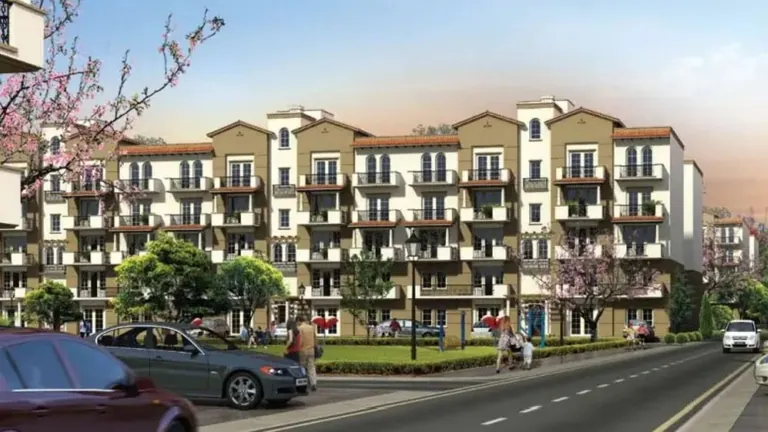 Emaar MGF Emerald Floors Premier blocks seen from the main road at dusk, artist's impression
