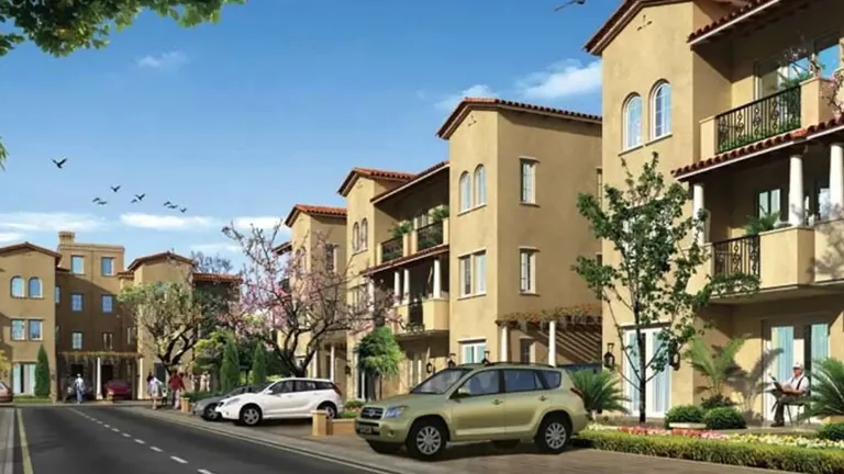 Emaar MGF Emerald Floors three-storey builder floors with balconies along a tree-lined road, artist's impression