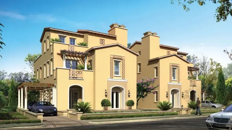 Emaar MGF Marbella Villas pair of Mediterranean-style villas with arched porches along a lane, artist's impression