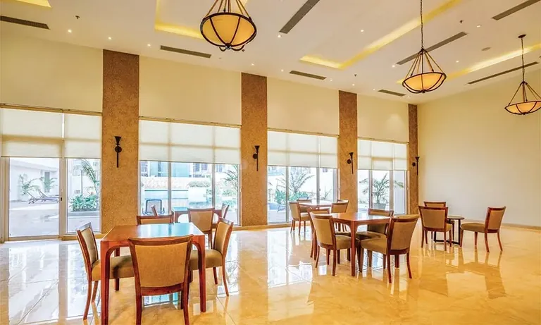 Experion The Heartsong clubhouse tea lounge with dining tables, actual photo