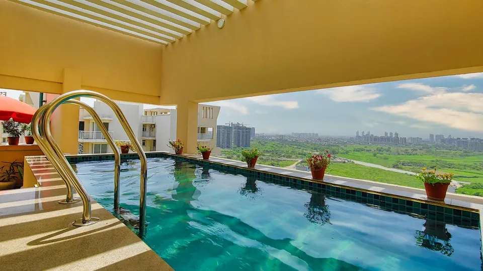Experion The Heartsong swimming pool overlooking open greens, actual photo