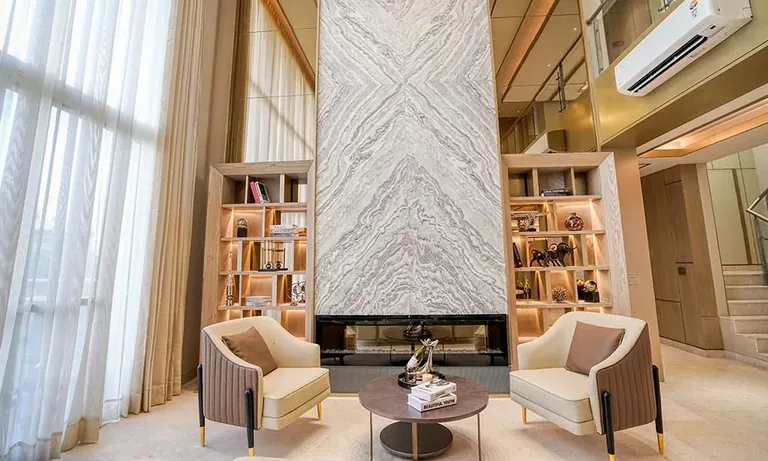 Experion Windchants duplex villament lounge with marble fireplace wall, actual photo