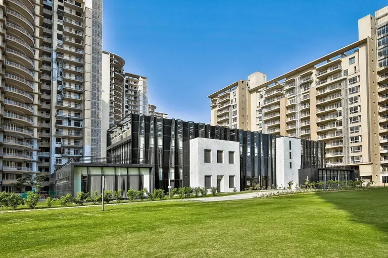 Indiabulls Enigma clubhouse and open lawn in daylight, photo