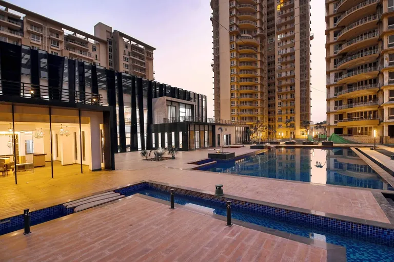 Indiabulls Enigma wooden pool deck beside the clubhouse at dusk, photo