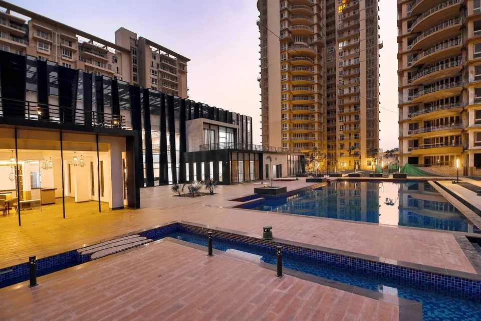 Indiabulls Enigma wooden pool deck beside the clubhouse at dusk, photo