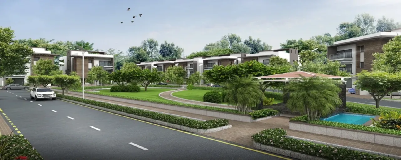 Ireo City Plots tree-lined colony road with homes and a lake, artist's impression
